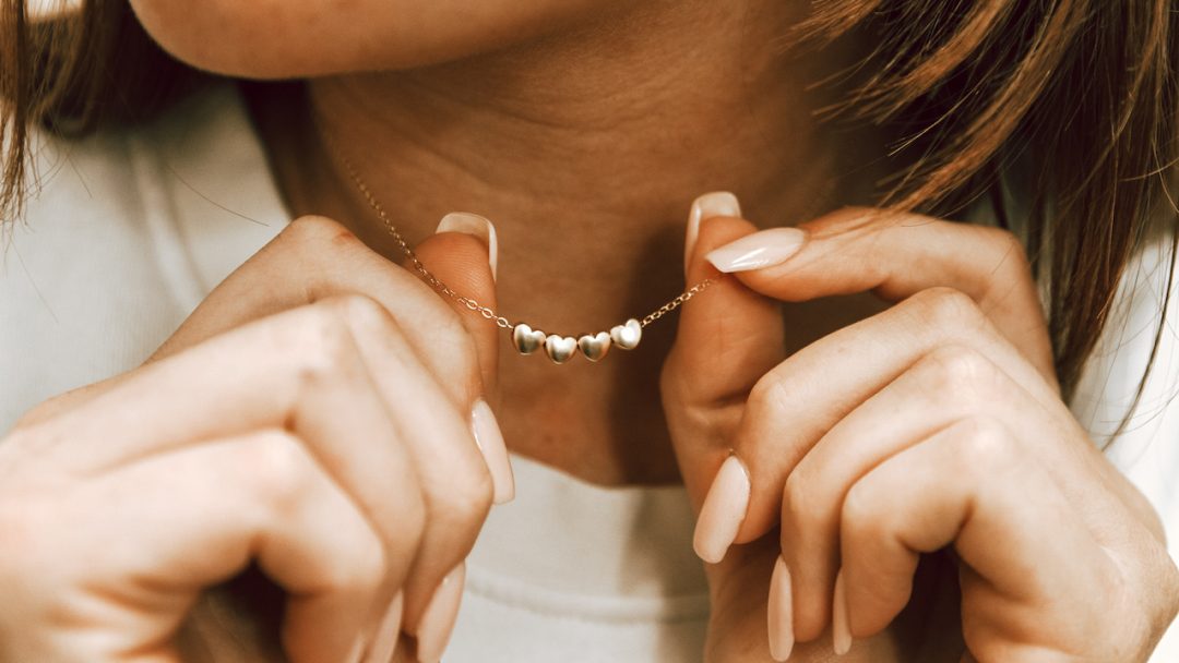 Golden Heart Necklace displayed by a mom as her Valentine's Day Gift